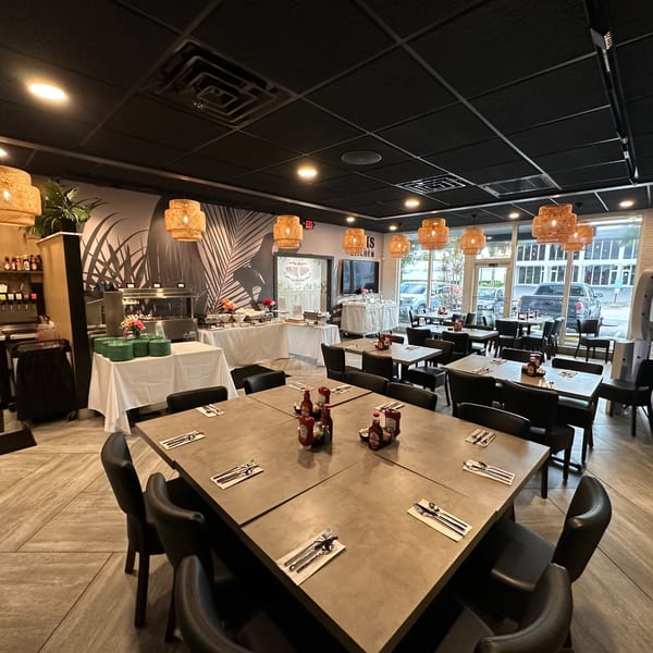 Interior of Mom's Kitchen, a breakfast restaurant, with set tables and a buffet area.